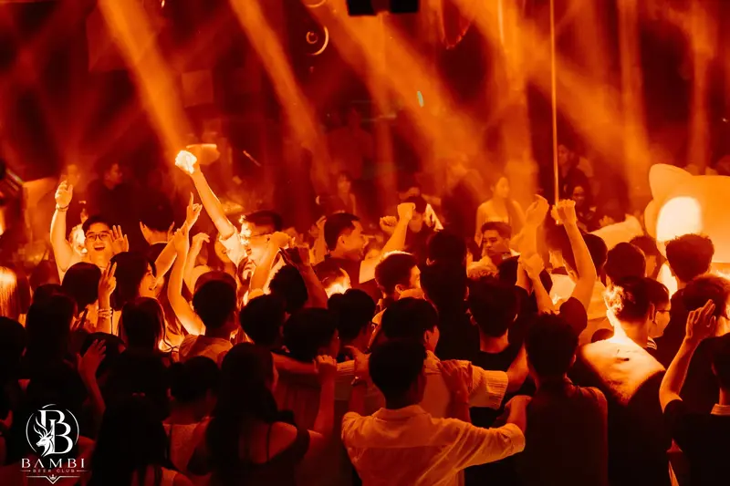 Khách quẩy hết mình dưới ánh đèn cam tại Bambi Beer Club